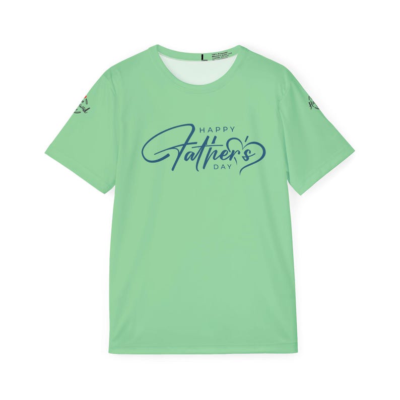 May include: A light green t-shirt with the text "HAPPY Father's DAY" in blue script. The shirt has short sleeves and a crew neck. The design includes a heart shape incorporated into the word "Father's".
