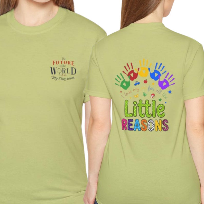 May include: A light olive green t-shirt featuring a small chest graphic that reads The Future of the World is in My Classroom. The back displays colorful handprints, small icons, and the text I love my job for all the Little REASONS.