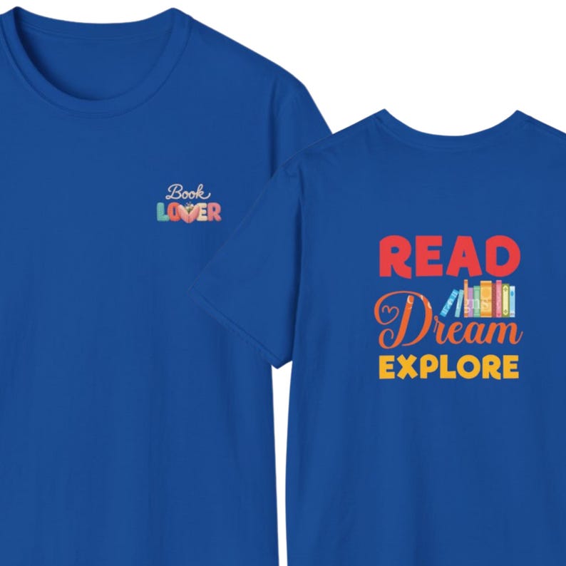 May include: A royal blue t-shirt featuring a small graphic on the chest that says Book Lover with a heart icon. The back of the shirt displays the text READ Dream EXPLORE in red, orange, and yellow, accompanied by a row of colorful book spines.
