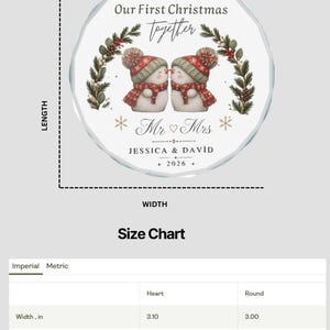 May include: A round glass Christmas ornament featuring two snowmen wearing red and green winter hats and scarves, with the text Our First Christmas Together, Mr & Mrs, JESSICA & DAVID, and 2026. The round ornament measures 3.00 inches in width and height.