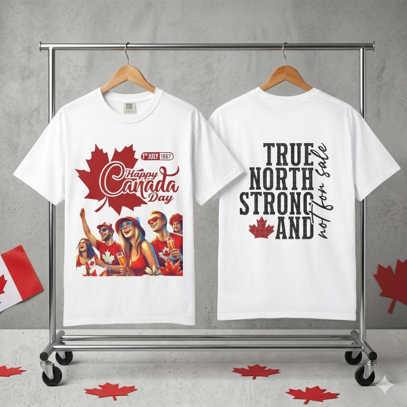 May include: White t-shirts with Canada Day graphics. One shirt features a red maple leaf and the text "Happy Canada Day" with a graphic of people celebrating. The other shirt has "True North Strong and" text.