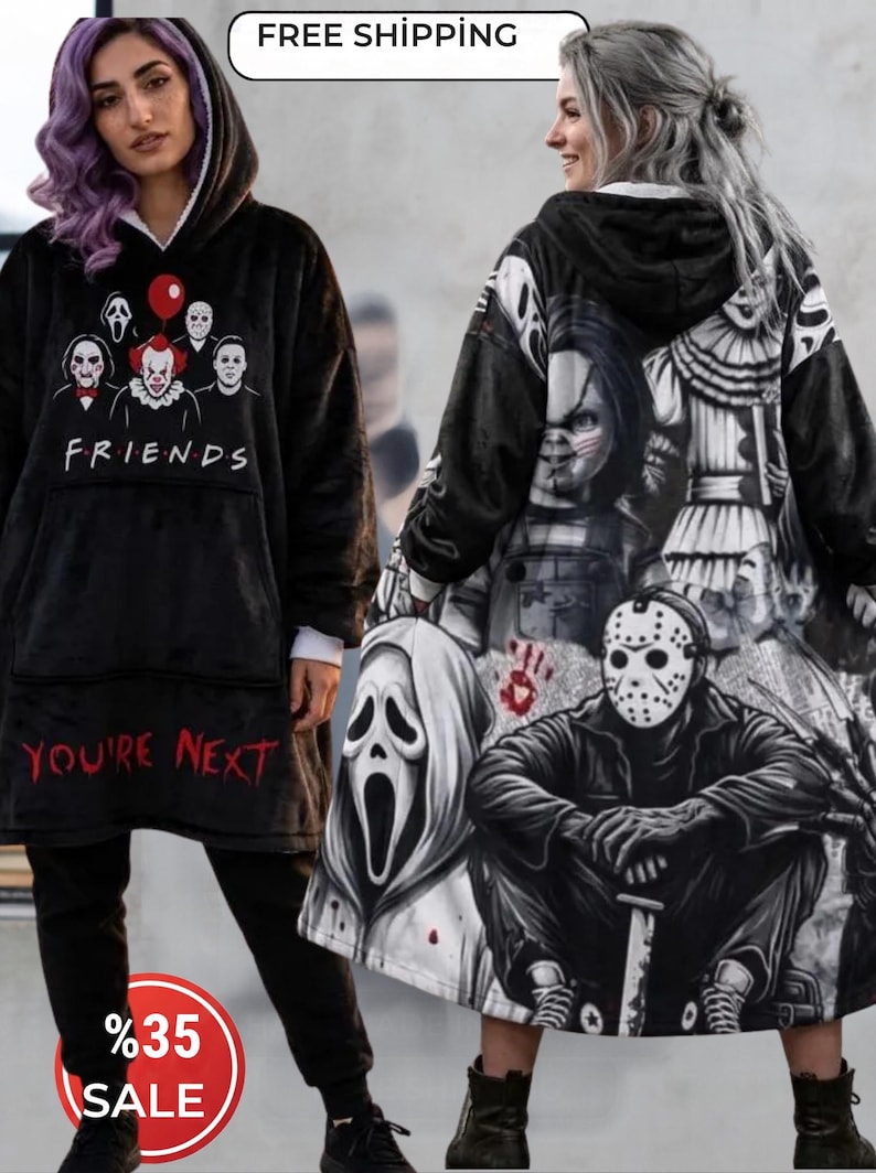 May include: A black hooded blanket sweatshirt featuring a graphic of horror movie characters and the text FRIENDS and YOU'RE NEXT on the front, with a large back print of various horror icons including a masked figure and a doll.
