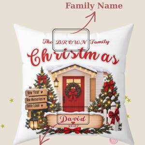 May include: A white square throw pillow featuring a festive holiday scene with a red front door, two decorated Christmas trees, and a wooden sign. The text reads The BROWN Family Christmas, New Year, New Memories, Same Love, David, and 2027.