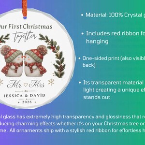 May include: A round crystal glass ornament featuring a printed illustration of two snowmen wearing red hats and scarves. The text reads Our First Christmas together, Mr & Mrs, JESSICA & DAVID, and 2026. It includes a red ribbon for hanging.