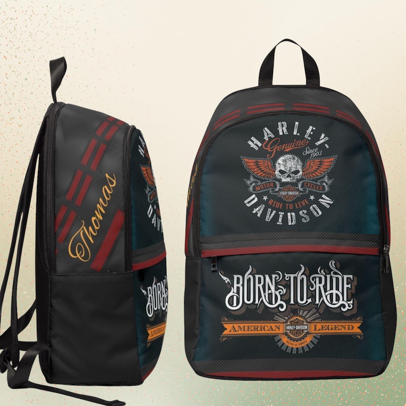 May include: A black backpack featuring Harley-Davidson branding with a skull and wings graphic, the text "BORN TO RIDE" and "AMERICAN LEGEND," and the name "Thomas" printed in gold script on the side panel with red accent stripes.