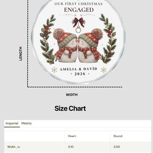 May include: A round, clear glass Christmas ornament featuring two snowmen wearing red and white patterned hats and scarves. The text reads OUR FIRST CHRISTMAS ENGAGED, AMELIA & DAVID, and 2026. A size chart indicates a width and height of 3.00 inches.