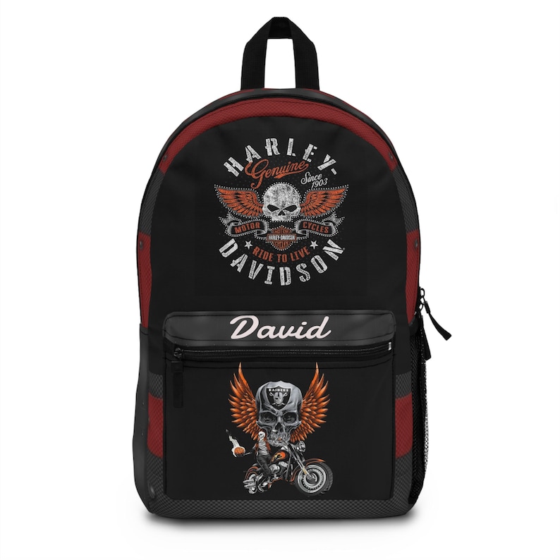May include: A black backpack with red side panels featuring a Harley-Davidson logo with a skull and wings on the top section. The front pocket displays the name David in white script above a graphic of a skull with wings riding a motorcycle.