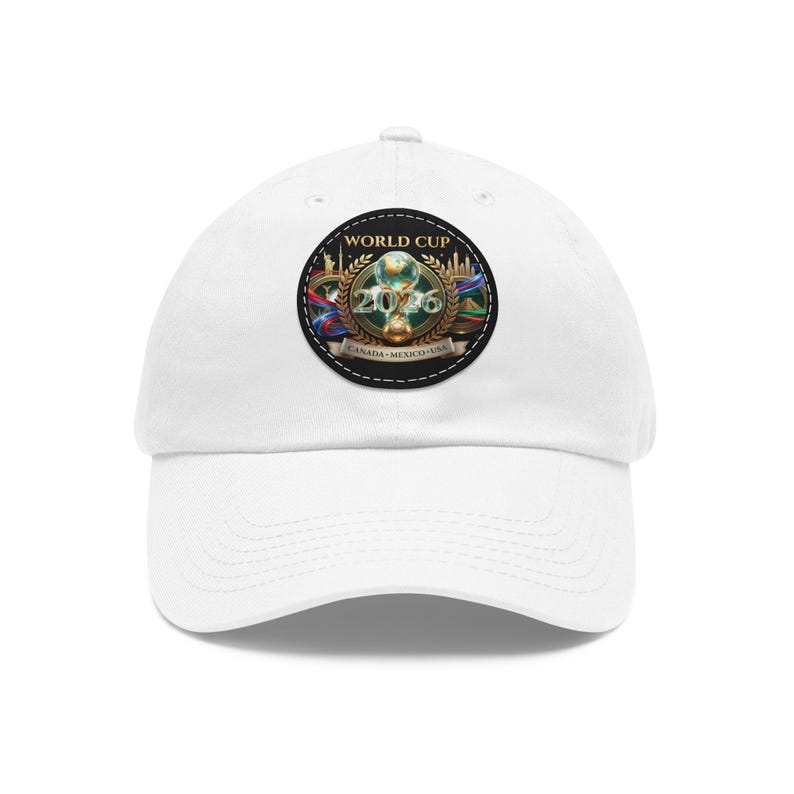May include: White baseball cap featuring a circular patch with the text "WORLD CUP 2026" and the flags of Canada, Mexico, and the USA. The patch includes a gold trophy and the words "CANADA MEXICO USA".