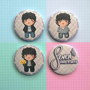 May include: Four round pins with a white background and a purple grid pattern. One pin features a cartoon character wearing a blue jacket and jeans. Another pin features a cartoon character wearing a black jacket and jeans. The third pin features a cartoon character wearing a black jacket and jeans holding a bouquet of yellow flowers. The fourth pin features the text "Seven Days A Week" in a purple script font.