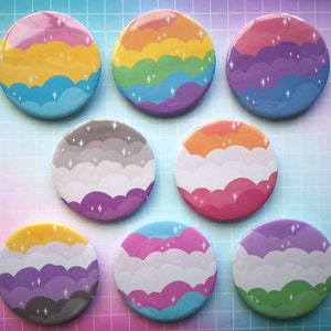 May include: Set of 8 round pins with different pride flag designs. Each pin features a different color scheme with a cloud pattern. The pins are perfect for showing your pride and supporting the LGBTQ+ community.