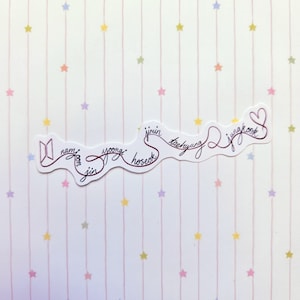 May include: A white die-cut sticker featuring a continuous dark red line that forms the names Namjoon, Jin, Yoongi, Hoseok, Jimin, Taehyung, and Jungkook in cursive script, ending in a heart shape and the BTS logo on the left side.