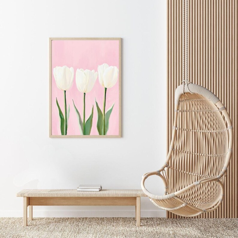 May include: A framed print of three white tulips on a pink background. The tulips are arranged in a row and have green stems and leaves.