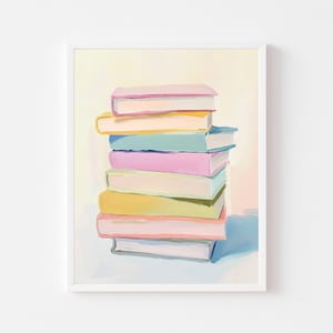 May include: A framed art print featuring a stack of colorful books. The books have pastel-colored covers in shades of pink, yellow, blue, and purple. The artwork is set against a soft, light background, creating a gentle and inviting aesthetic.