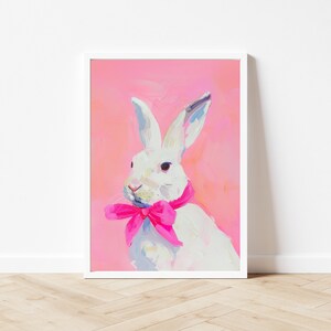 May include: A white rabbit with pink ears and a pink bow tie on a pink background.