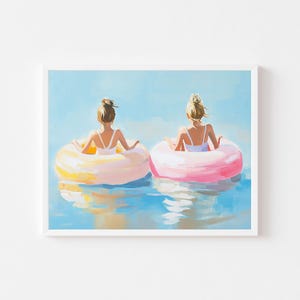 May include: Two people float on colorful inflatable rings in a blue body of water. The person on the left is on a yellow ring and the person on the right is on a pink ring. Both people are facing away from the viewer.
