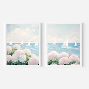 May include: Two framed art prints. Each features a seascape with sailboats on blue water under a light blue sky with clouds. Pink and white hydrangeas are in the foreground.