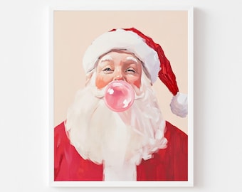 May include: A framed print of Santa Claus blowing a pink bubble. Santa is wearing a red suit and hat with white trim and a fluffy white beard. The background is a light peach color.