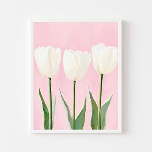 May include: Three white tulips with green stems and leaves on a pink background.