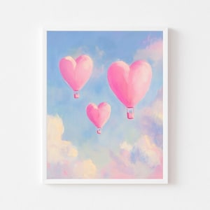 May include: Three pink heart-shaped hot air balloons float in a pastel blue sky with white clouds.