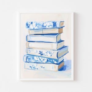 May include: A stack of books with blue and white patterned covers. The books are arranged in a vertical stack, with the top book being the largest and the bottom book being the smallest. The books are all in focus, and the background is a light cream color.