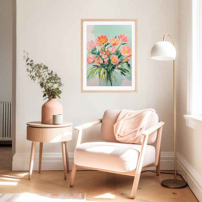Puede incluir: Una impresi&oacute;n enmarcada de una pintura que representa un ramo de flores rosas en un jarr&oacute;n sobre un fondo azul claro. La impresi&oacute;n est&aacute; colgada en una pared blanca en una habitaci&oacute;n con una silla y una mesa auxiliar.