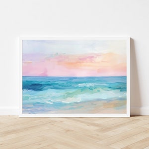 Peut inclure: Une peinture repr&eacute;sentant un paysage marin avec un coucher de soleil rose et orange au-dessus d'une mer bleue avec des vagues blanches qui se brisent sur le rivage.