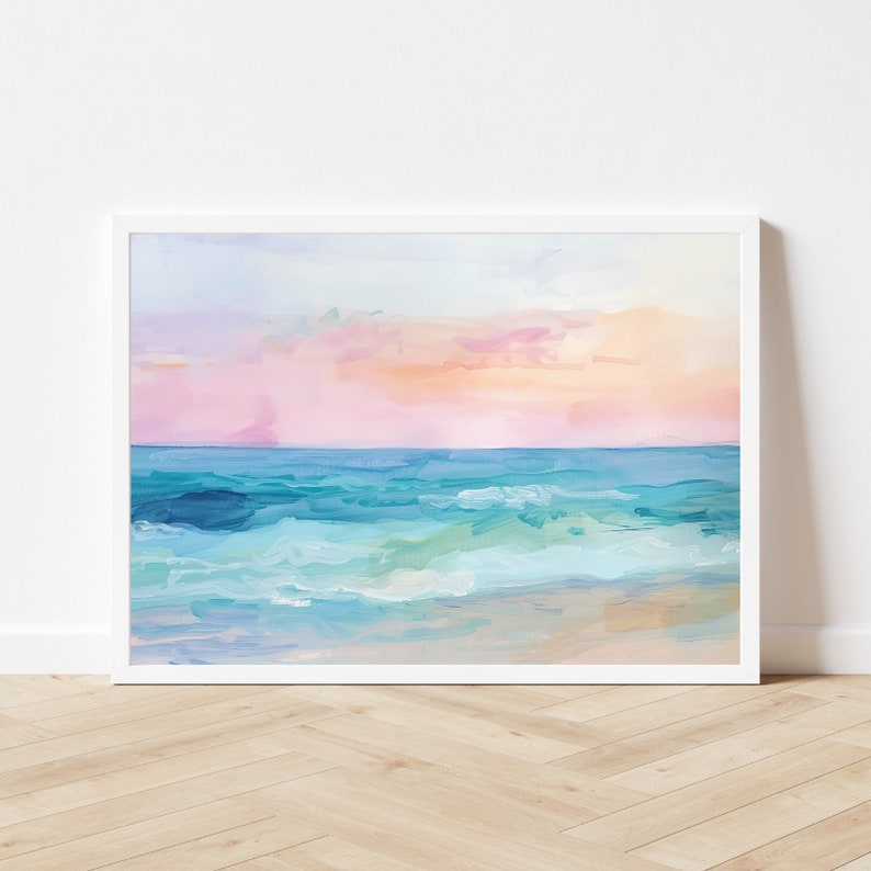 Peut inclure: Une peinture repr&eacute;sentant un paysage marin avec un coucher de soleil rose et orange au-dessus d'une mer bleue avec des vagues blanches qui se brisent sur le rivage.