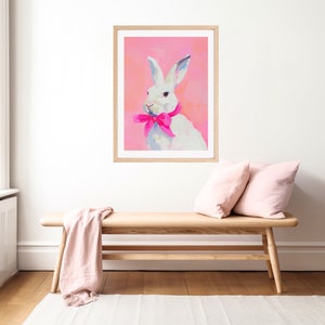 May include: A white rabbit with pink ears and a pink bow tie on a pink background.