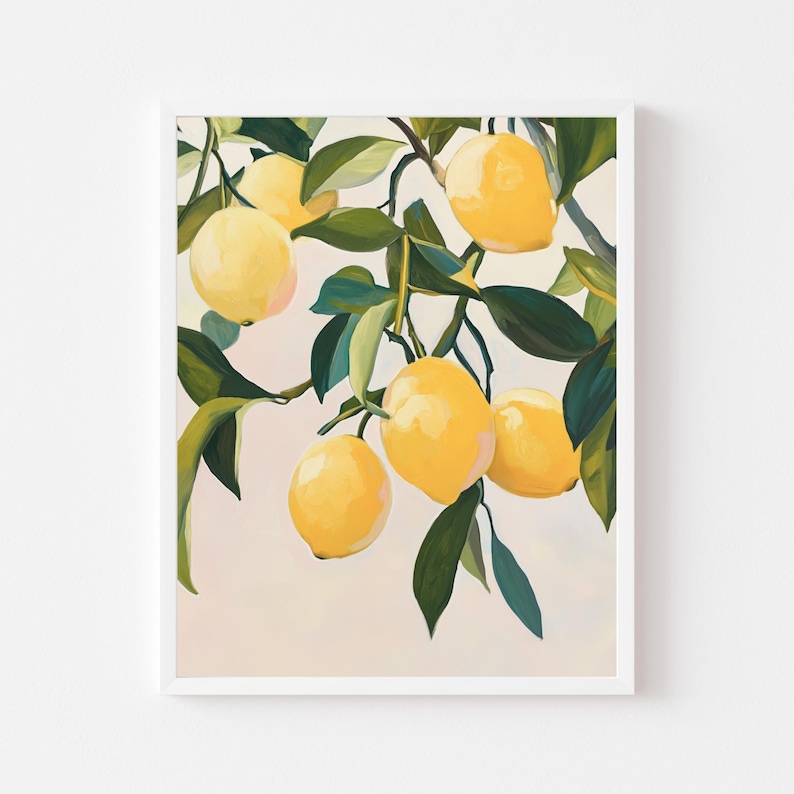 May include: A framed art print featuring a branch of lemons. The lemons are a bright yellow, contrasted by the dark green leaves. The background is a soft, muted pink. The artwork is in a white frame.
