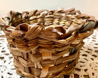 Small handmade natural basket made of bromeliad, narcissus and yucca