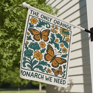 May include: A rectangular flag with the text "THE ONLY ORANGE MONARCH WE NEED" and a design featuring orange monarch butterflies, teal leaves, and yellow flowers. The flag is mounted on a white pole.