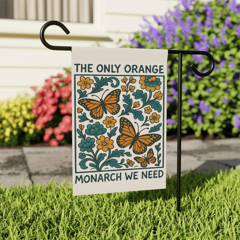 Subtle anti Trump flag reading The Only Orange Monarch We Need with bright orange butterflies and flowers, a funny political garden flag that adds activism and humor to your yard.