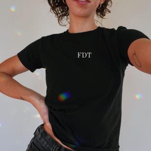 Minimalist anti Trump shirt in black, FDT baby tee. Subtle political tshirt for feminist women, great social justice tee gift.