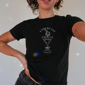 lesbian baby tee with martini glass graphic. Subtle bi pride top and and cowgirl lesbian shirt.
