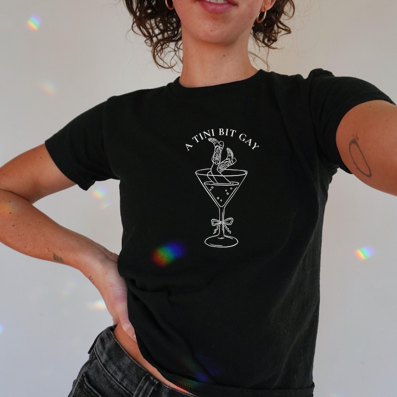 lesbian baby tee with martini glass graphic. Subtle bi pride top and and cowgirl lesbian shirt.