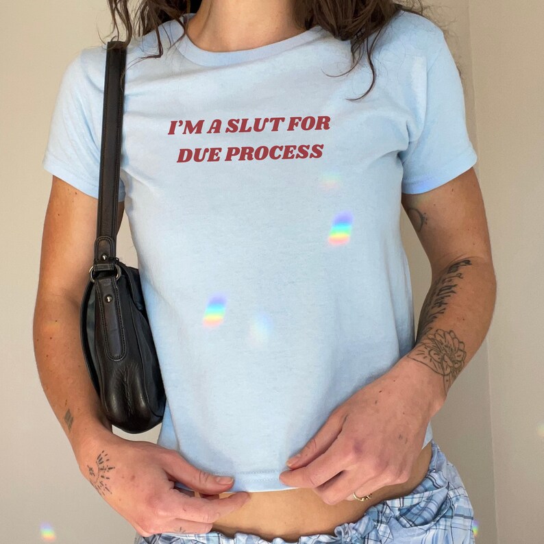 Y2K baby tee and due process shirt for women with red text "I'm A Slut For Due Process". An anti Trump shirt and political baby tee.