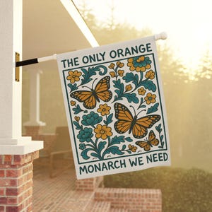 subtle anti Trump flag showing vibrant monarch butterflies and detailed floral artwork, a feminist garden flag and peaceful protest yard sign supporting democracy and equality.