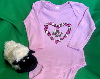 Delightful long-sleeved infant and toddler bodysuits with original inspirational designs for girls and boys in soft cotton with snap bottoms