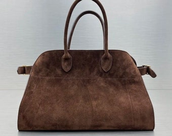 Fashionable suede tote handbag with a soft suede top handle, perfect for women seeking a stylish and versatile accessory
