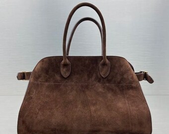 Fashionable suede tote handbag with a soft suede top handle, perfect for women seeking a stylish and versatile accessory