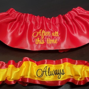 May include: Red and yellow satin garter with the text "After all this time" and "Always" embroidered in gold thread.