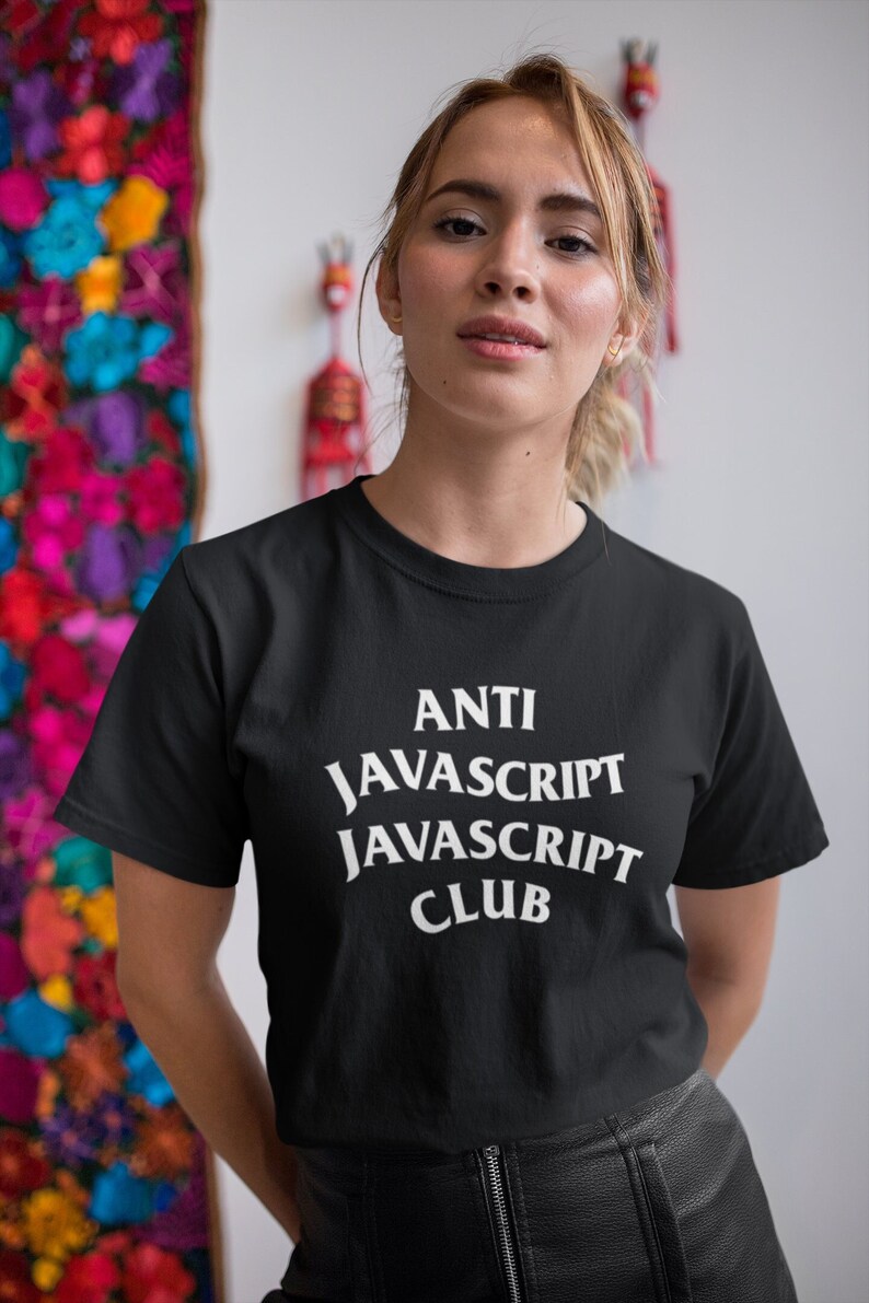May include: A black t-shirt with white text that reads "ANTI JAVASCRIPT JAVASCRIPT CLUB".