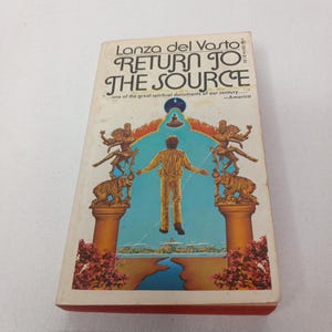 May include: Book cover with a blue and orange illustration of a person floating in the air with a blue sky and a river in the background. The book title is "Return to the Source" by Lanza del Vasto.