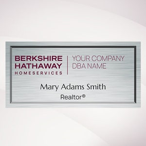 May include: A silver metal business card with a black border. The text on the card reads "Berkshire Hathaway Homeservices", "Your Company DBA Name", "Mary Adams Smith", and "Realtor®".