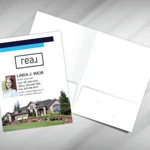 May include: A blue and white real estate business card with the text "геал" and "LINDA J. WEIR" in a white square. The card also includes a photo of a woman, contact information, and a photo of a house.
