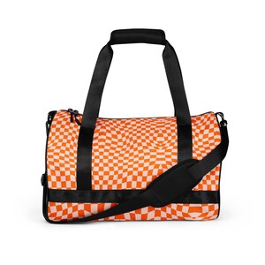 May include: Orange and white checkered duffel bag with black straps and a shoulder strap.