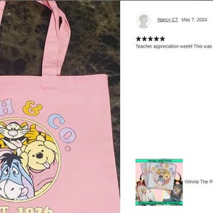 a pink tote bag with a picture of winnie the pooh on it