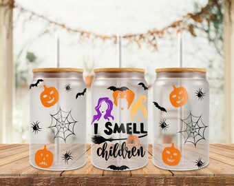 May include: Three clear glass can wraps with wooden lids and straws. Each wrap features Halloween-themed designs, including orange jack-o'-lanterns, spiderwebs, bats, and spiders. The middle wrap has the text "I SMELL children".