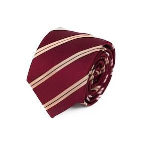 May include: A burgundy and cream striped tie rolled up. The tie is made of a silky material.