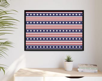 May include: A framed print of a red, white, and blue striped pattern with white stars. The print is in a black frame and is hanging on a white wall.